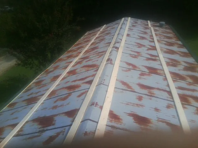 Rusted metal roof panels with new wood purlins before replacement — Storm Damage Roof Repair in Hensonville by Roofing Brothers